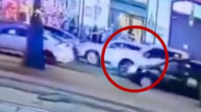 A still image from CCTV footage showing several cars on a road and white pick-up truck circled in red.