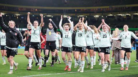 Wales' Gemma Evans (second left to right), Mary McAteer, Ella Powell, Carrie Jones, Ceri Holland and team-mates celebrate after winning the UEFA Women's Euro 2025 Qualifying play off round two, second leg match at the Aviva Stadium, Dublin in Ireland