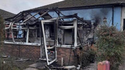 An outbuilding at the school severely damaged with black burn marks