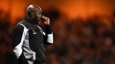 Darren Moore surveys the scene at Vale Park on the night he watched his team play in front of their biggest home crowd since he became manager