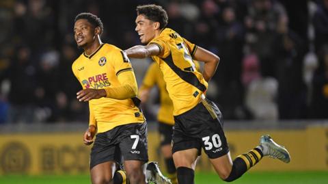 Newport County's Bobby Kamwa (L) celebrates with Noah Mawene