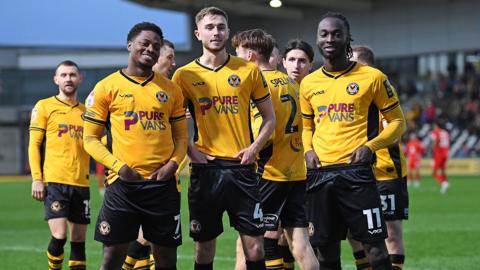 Bobby Kamwa, Matt Baker and Cameron Antwi celebrate during Newport's win over MK Dons 