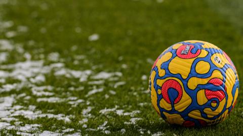 Football on frozen pitch