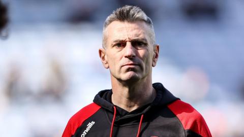 Former Derry GAA manager Rory Gallagher - a man with grey hair and wearing a black and red O'Neill's hoody