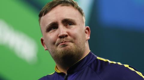 A tearful Luke Littler on stage at Alexandra Palace