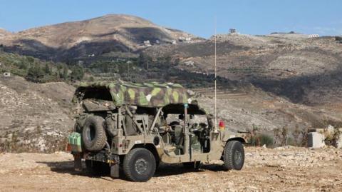 Israeli troops deploy next to the security fence near the Druze village of Majdal Shams, in the Israeli-occupied Golan Heights (8 December 2024)