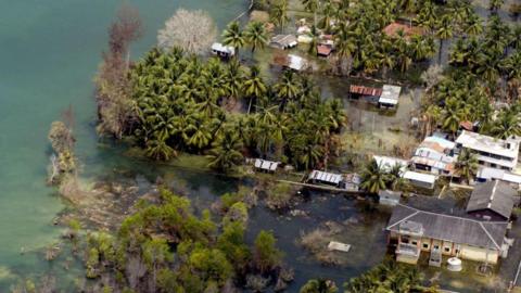 This aerial view from an Indian Navy Helicopter taken 28 February 2005, shows an abandoned waterlogged coastal village on Kamorta Island, part of the Andaman and Nicobar Islands. India has given up hope of rebuilding six islands in the tsunami-hit Andaman and Nicobar archipelago where 5764 people are still listed as missing and some 40,500 people are placed in makeshift camps waiting for their homes to be rebuilt by the Integrated Relief Command (IRC), comprising the military and the civilian administration, set up by India to restore the Andamans. 