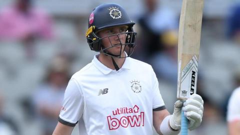 Fletcha Middleton raises his bat after reaching 50 for Hampshire 