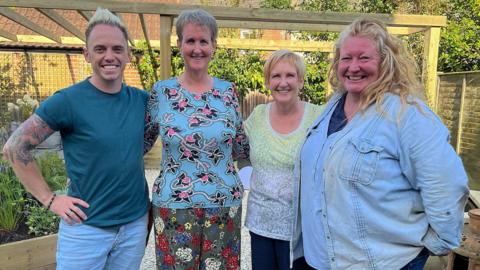 Smiling and posing for the camera, left to right, are Lee Burkhill, Sonia Booth, her sister, Val, and Charlie Dimmock