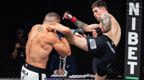 Connor Hughes aims a kick at his opponent during a fight