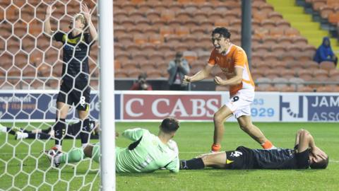 Blackpool forward Kyle Joseph celebrates after Will Aimson's late own goal secured a 2-2 draw against Wigan.