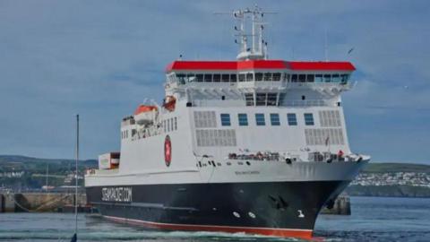 The front of Ben-my-Chree, which is a large black, white and red box like ferry, as it turns in Douglas Harbour.