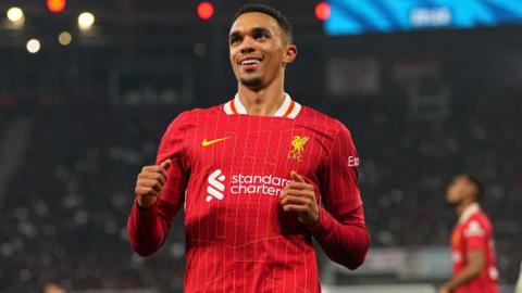 Trent Alexander-Arnold smiling while running on the pitch