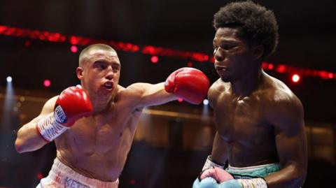 Nick Ball aims a punch at a bloodied Raymond Ford