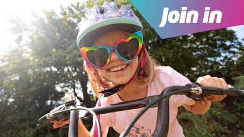 girl smiling on a bike