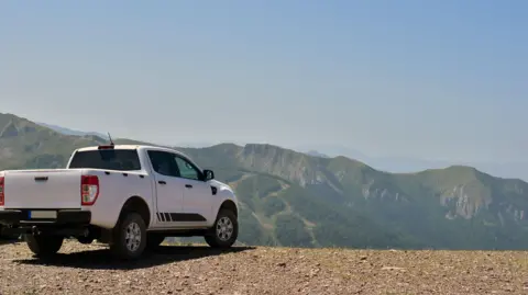 File image of a pickup truck parked in front of mountains