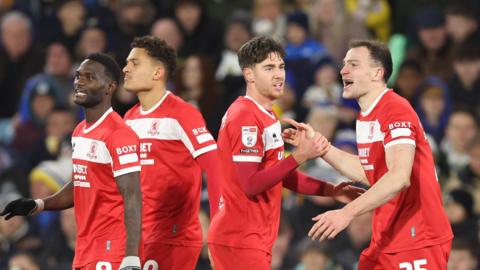 Middlesbrough players gathered together after scoring at Leeds