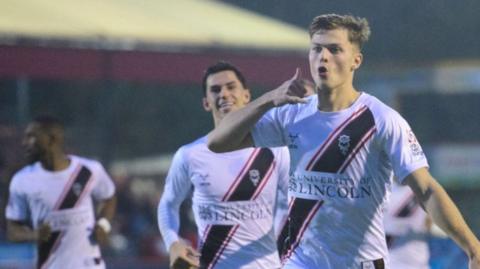 Lincoln's Erik Ring celebrates a goal at Crawley