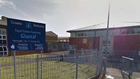 Google image of the entrance to Ysgol Gyfun Gymraeg Glantaf in Cardiff, showing fencing, road and school buildings, as well as the entrance sign