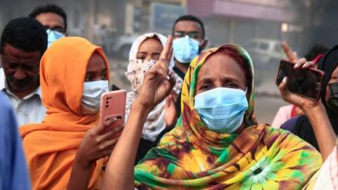 Sudanese protesters gesture during a demonstration in the capital Khartoum