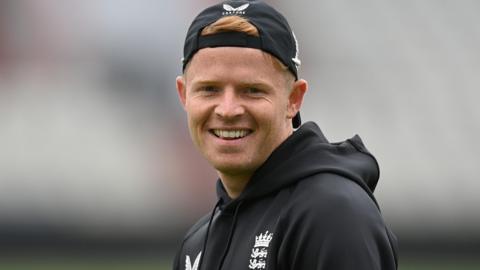 Ollie Pope smiles during England training