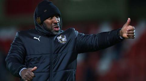 Darren Moore gives a thumbs up after a Port Vale match