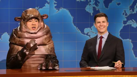 Bowen Yang as Moo Deng and Colin Jost on Saturday Night Live