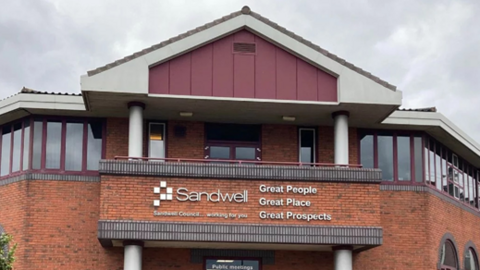 A red brick council building with a sign that reads 'Sandwell'