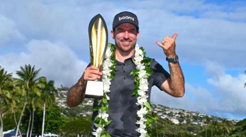 Nick Taylor celebrates his Sony Open win with the trophy