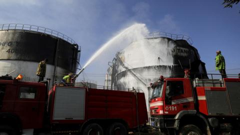 Firefighters extinguish a fire at a power station following Israeli air strikes in Sanaa, Yemen (19 December 2024)