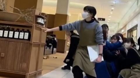 People crouch inside shopping mall during earthquake in Japan