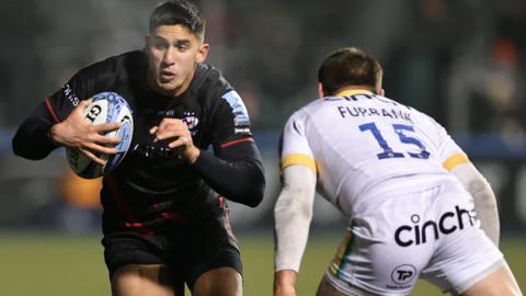 Lucio Cinti of Saracens takes on George Furbank of Northampton Saints 