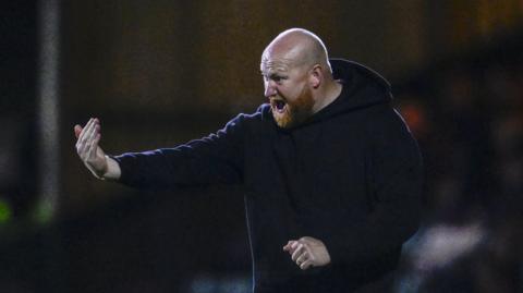 Solihull Moors boss Andy Whing waves instructions