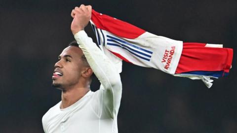 Gabriel waves his shirt in celebration