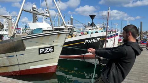 A man pulling a fishing boat