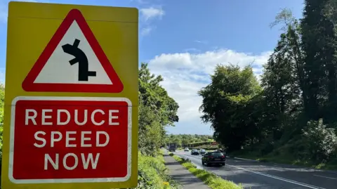 A road sign on the A5 saying slow down