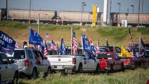 Attendees ride in vehicles during a "Trump train" rally in Texas in 2020