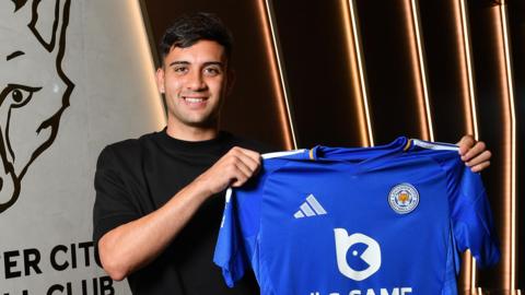 Facundo Buonanotte holds up a Leicester shirt