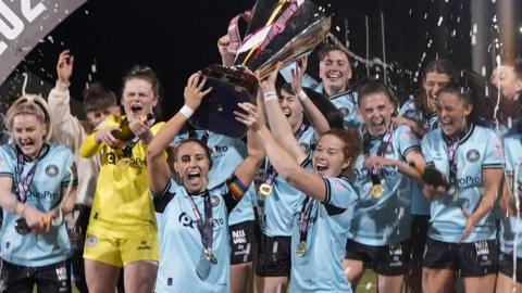 Cliftonville's Marissa Callaghan and Kelsie Burrows lift the Women's Premiership trophy