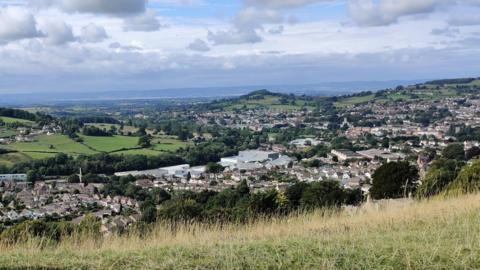 A view looking over Stroud from high, with small housing, taken from Selsey Common