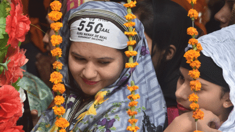 Sikh pilgrims take part in a religious ritual as they gather to celebrate the 550th birth anniversary of Guru Nanak Dev, at Nankana Sahib