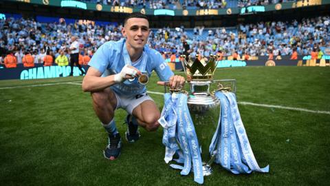 Phil Foden with the Premier League trophy