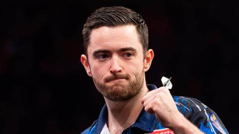 Luke Humphries celebrates beating Luke Littler at the European Darts Grand Prix 2024