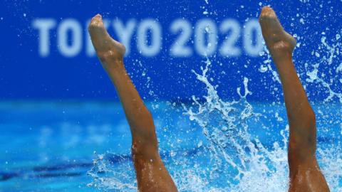 Competitors take part in an artistic swimming event at the Tokyo Olympics