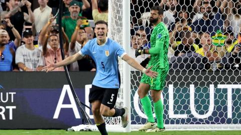 Manuel Ugarte celebrating after scoring the winning penalty for Uruguay