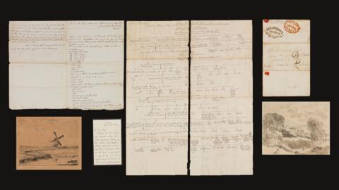 A number of letters from the Bishop of Salisbury to John Constable and pictures laid out on a black surface