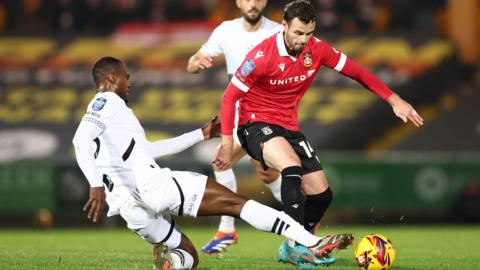 Rekeem Harper of Port Vale tackles Anthony Forde of Wrexham