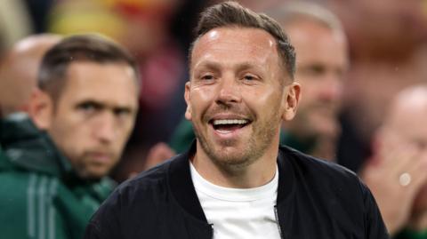 Craig Bellamy smiles as he watches Wales