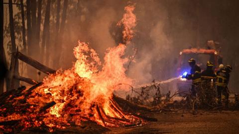 Firefighters combat a wildfire in Espiunca, Arouca, Portugal.