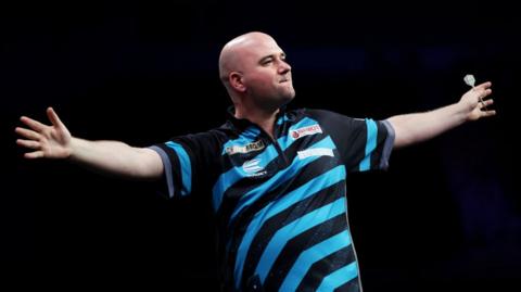 Darts player Rob Cross celebrating